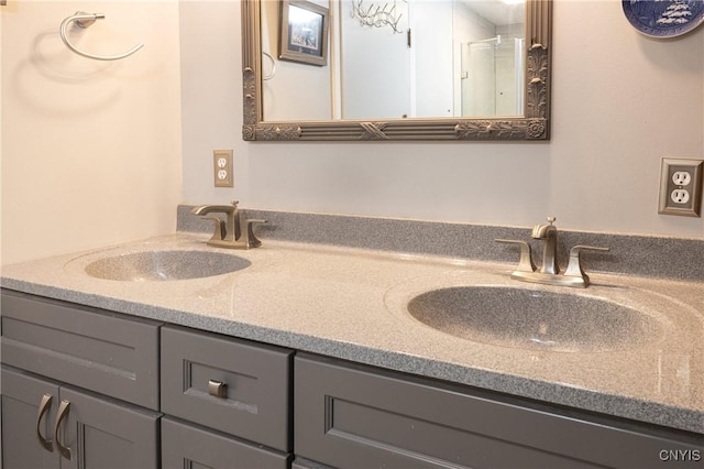 bathroom featuring a sink, a shower with door, and double vanity