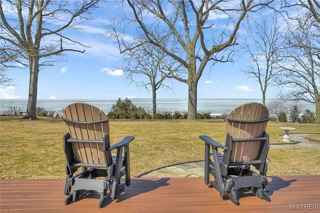 wooden deck with a yard and a water view