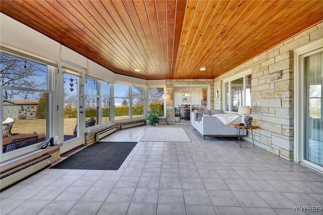 unfurnished sunroom featuring a baseboard heating unit and wooden ceiling