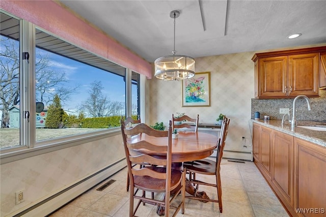 dining area featuring a baseboard heating unit, an inviting chandelier, wallpapered walls, light tile patterned floors, and baseboards