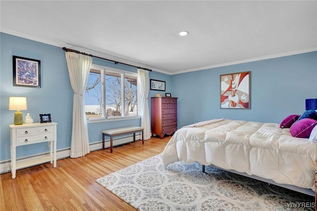 bedroom featuring baseboard heating, wood finished floors, baseboards, and ornamental molding