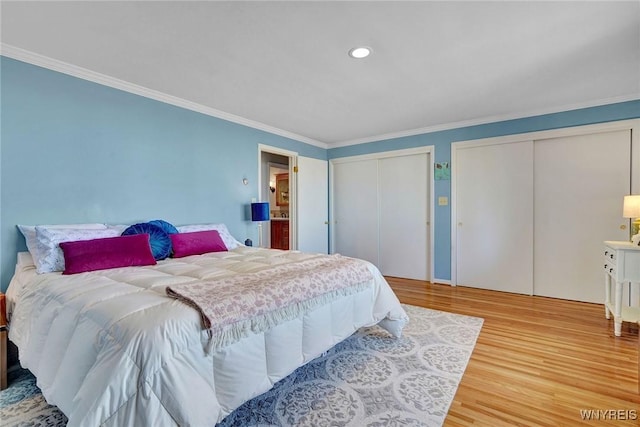 bedroom featuring recessed lighting, multiple closets, wood finished floors, and ornamental molding