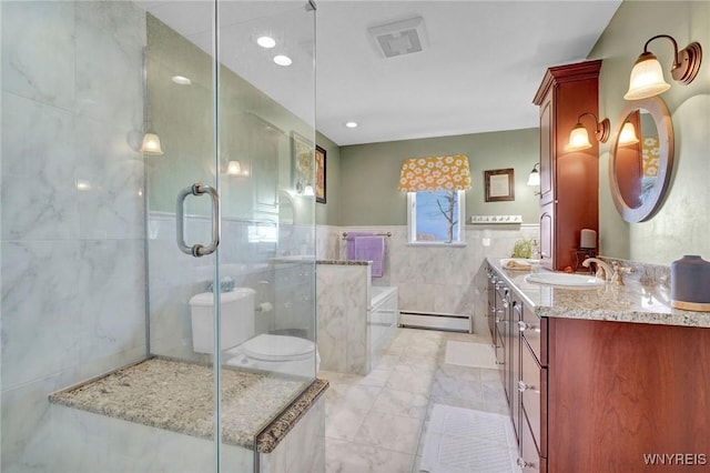 full bath with vanity, a stall shower, a bath, tile walls, and a baseboard radiator