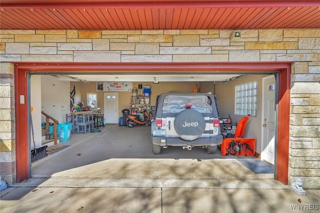 garage featuring concrete driveway