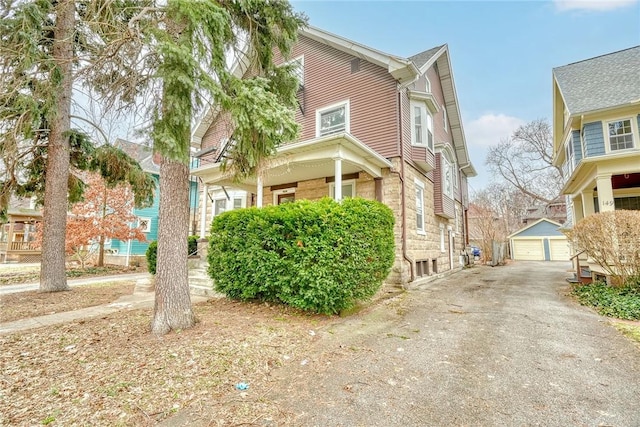 view of home's exterior featuring an outdoor structure and a detached garage