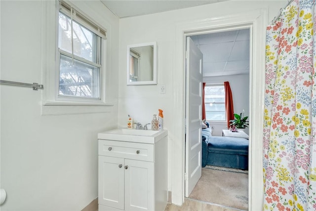 hall featuring a sink and a paneled ceiling