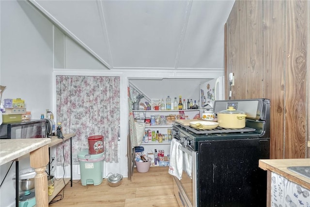 kitchen featuring light wood-style floors and stainless steel gas range oven