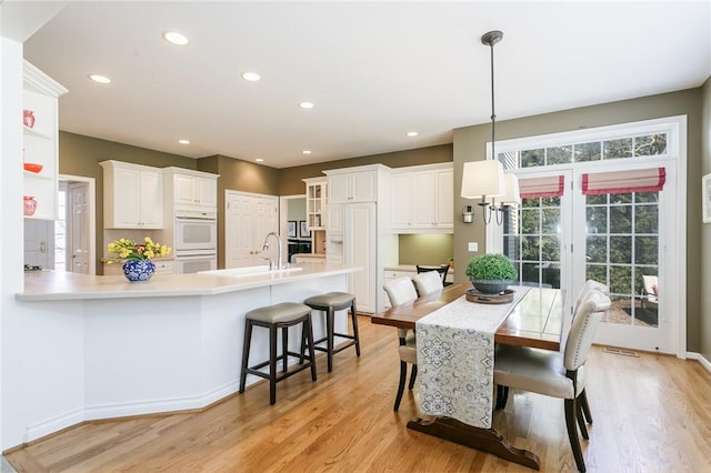 dining space featuring visible vents, recessed lighting, and light wood-type flooring