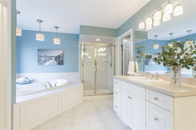 full bathroom featuring tile patterned floors, a stall shower, vanity, and a garden tub