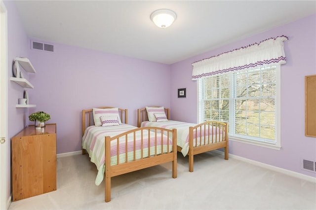 bedroom featuring visible vents, light carpet, and baseboards