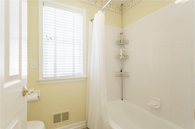 full bath featuring visible vents, toilet, and shower / bath combo