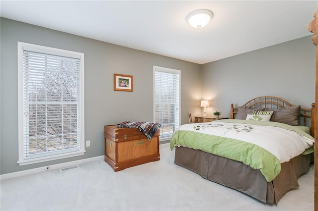 bedroom featuring visible vents, baseboards, and carpet