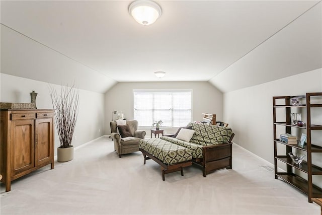 living area with light carpet, baseboards, and vaulted ceiling