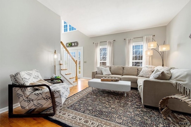 living area featuring stairway, baseboards, and wood finished floors