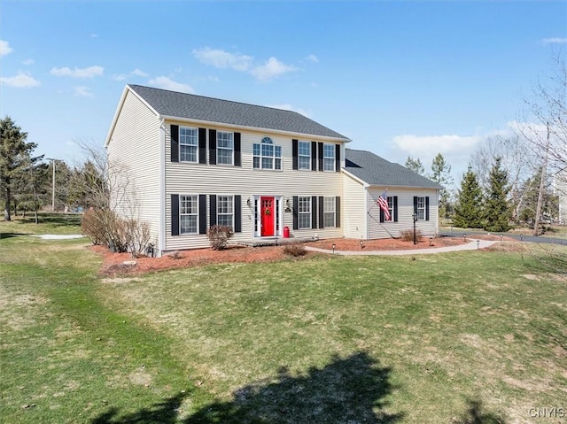 colonial home featuring a front yard