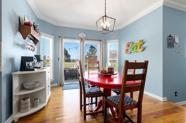 dining room with a wealth of natural light, baseboards, and light wood-style floors