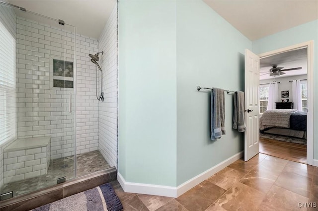 full bath with a shower stall, baseboards, and connected bathroom