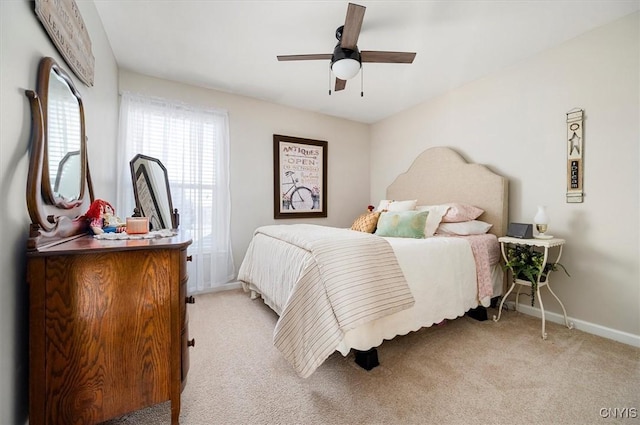 bedroom with light carpet, ceiling fan, and baseboards