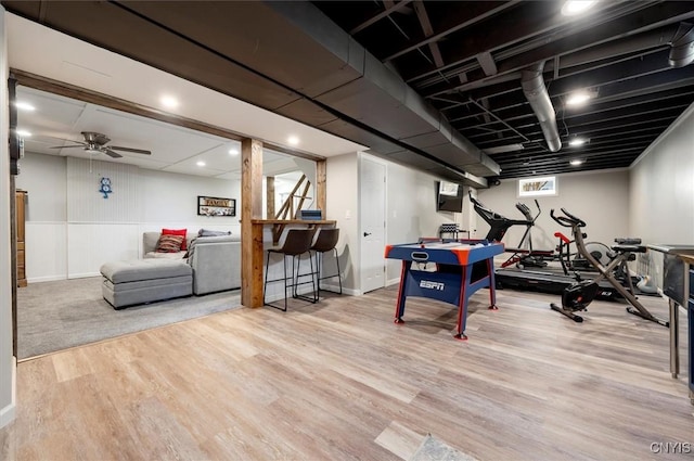 workout area featuring ceiling fan and wood finished floors