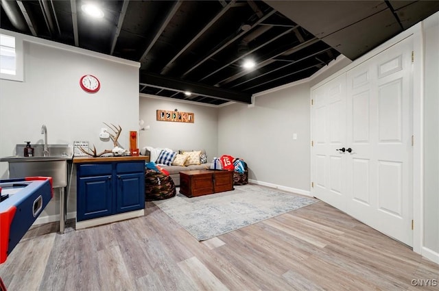 miscellaneous room with baseboards and light wood-type flooring