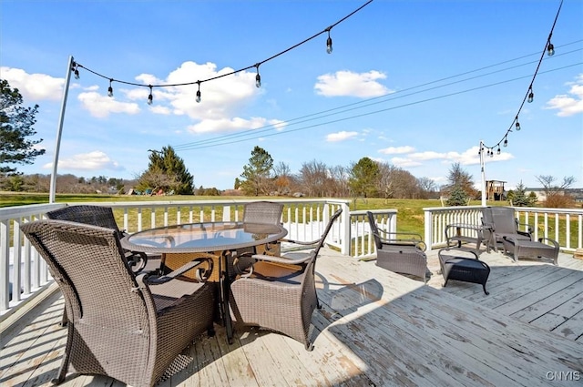 wooden terrace with outdoor dining area