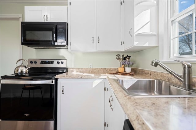 kitchen featuring plenty of natural light, stainless steel electric range, black microwave, and a sink