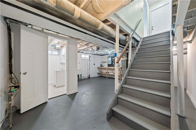 basement featuring stairway and washer / clothes dryer