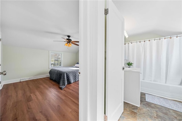 bedroom featuring visible vents, a ceiling fan, baseboards, and vaulted ceiling