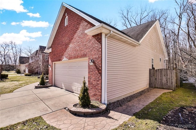 view of home's exterior featuring a garage, brick siding, and driveway