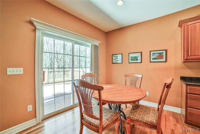 dining room with light wood-style floors and baseboards