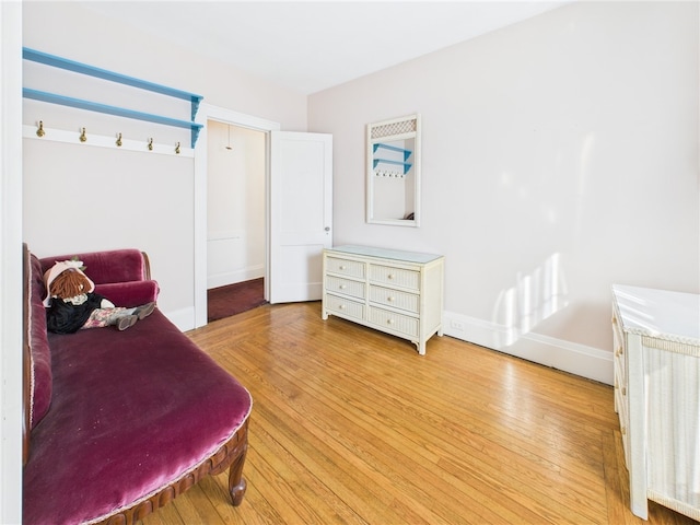 bedroom featuring baseboards and light wood-style flooring