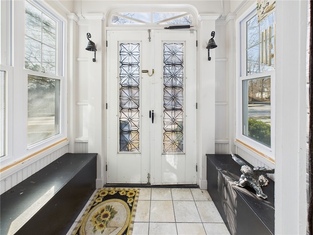 doorway with light tile patterned floors