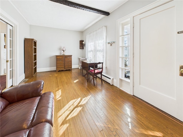 living room with beamed ceiling, baseboards, and wood-type flooring