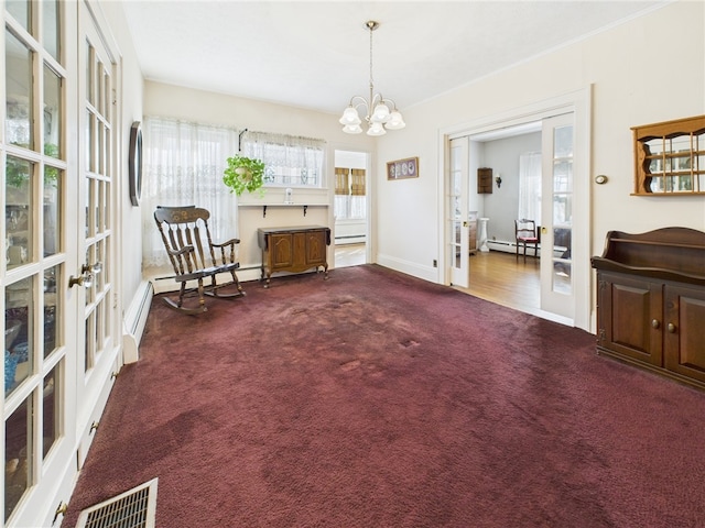 living area with visible vents, a baseboard heating unit, french doors, carpet floors, and an inviting chandelier