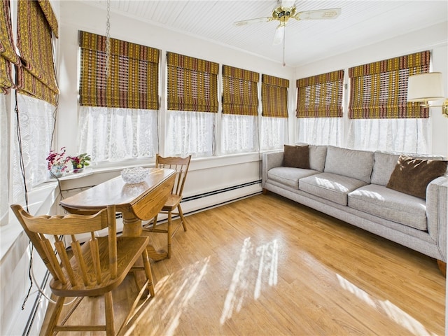 sunroom / solarium featuring a ceiling fan