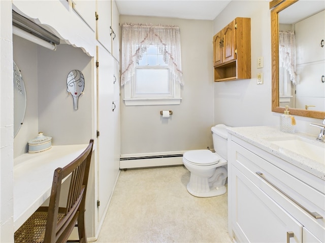 bathroom featuring baseboard heating, vanity, and toilet