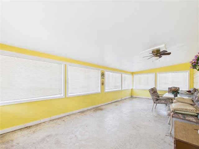 unfurnished sunroom with a ceiling fan