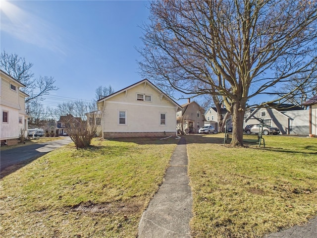 view of side of home with a lawn