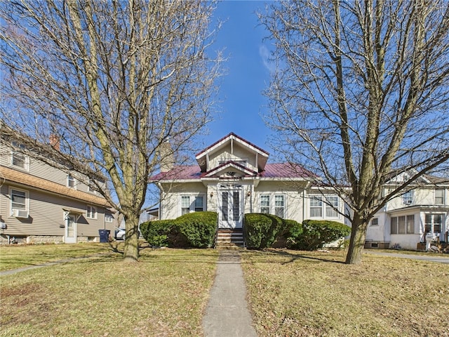 view of front facade with a front lawn, cooling unit, and stucco siding