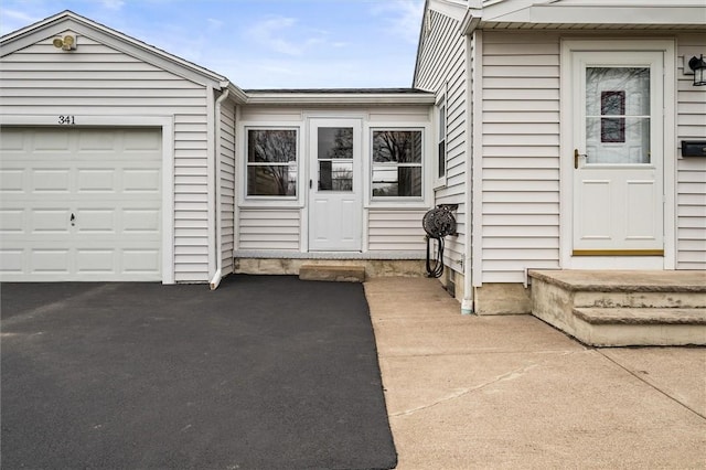 entrance to property featuring aphalt driveway