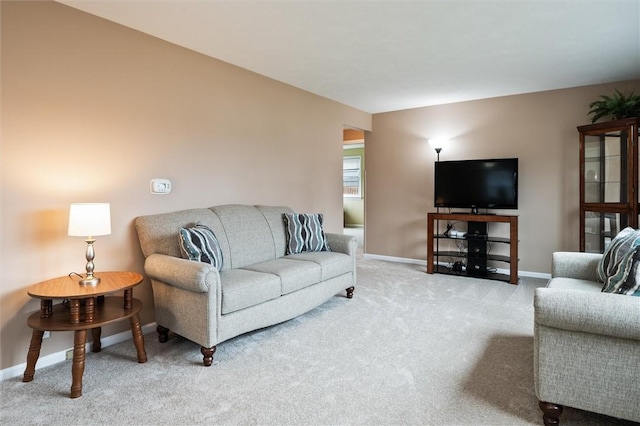 living area with baseboards and carpet floors