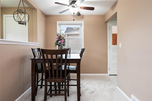 dining room with baseboards, carpet, and ceiling fan