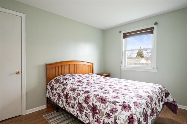 bedroom featuring baseboards and wood finished floors