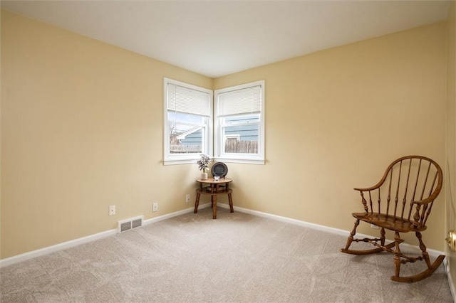 living area with carpet flooring, baseboards, and visible vents