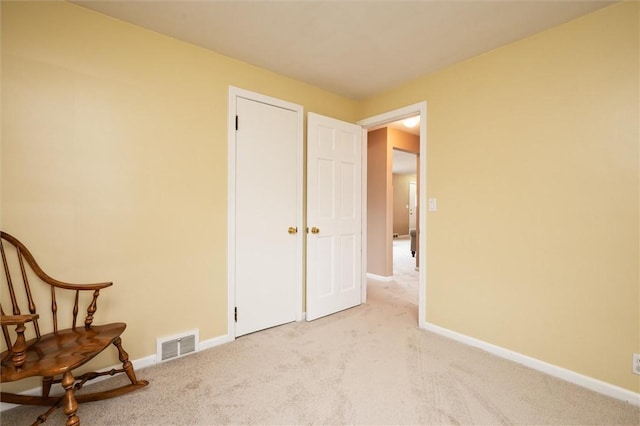 sitting room featuring visible vents, baseboards, and carpet