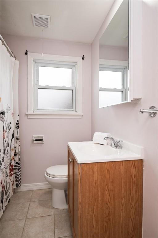 bathroom with visible vents, toilet, tile patterned flooring, baseboards, and vanity