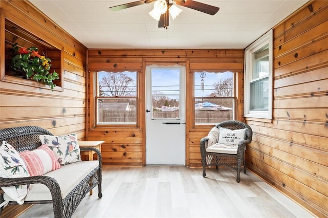 sunroom featuring a ceiling fan