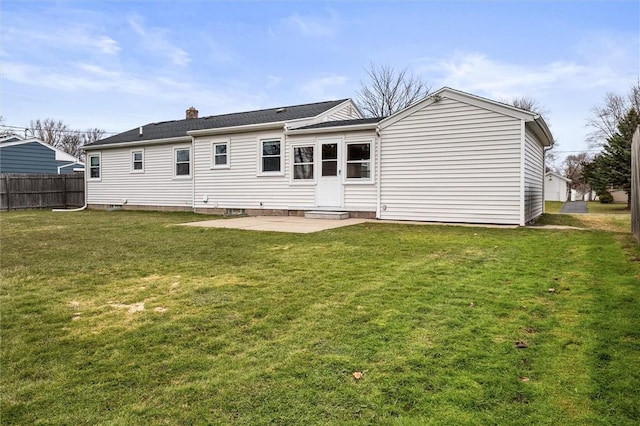 back of house with a yard, fence, a chimney, and a patio area