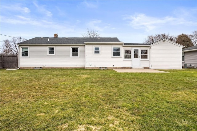 back of property with a patio, a yard, and fence