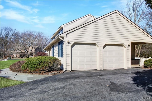 view of side of property with a garage and driveway